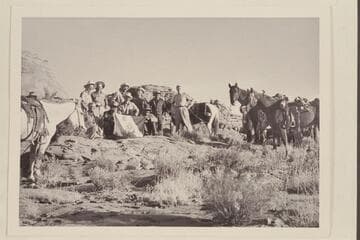 The crew of the Land Cruise of 1955 in Little Finger Canyon, a side canyon of Navajo Canyon.  Front:  Ballard Atherton, Bahe, Masland, Whitehat.  Standing:  Marston, Cutler, Visbak, Daly, a Navajo boy of the Manygoats family, Desloge