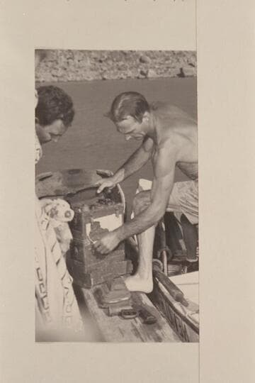 Nevills unloads the radio set recovered from the plateau below Point Sublime.  It was dropped to the aviation men who had parachuted into the canyon in 1944