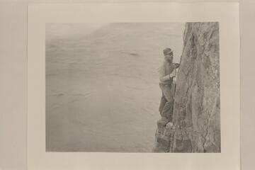 Johnny Maxson on cliff west of Monument Creek.  Caltech party  [on photo reverse:  John on a cliff west of Monument Creek]