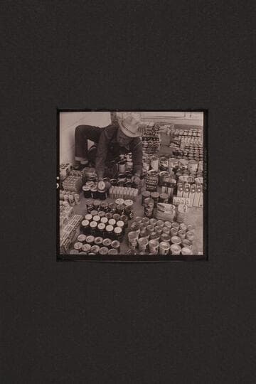 Bill Belknap checks the supplies at Boulder City before taking them to Lees Ferry and other points. Outboard motor traverse of the Grand Canyon